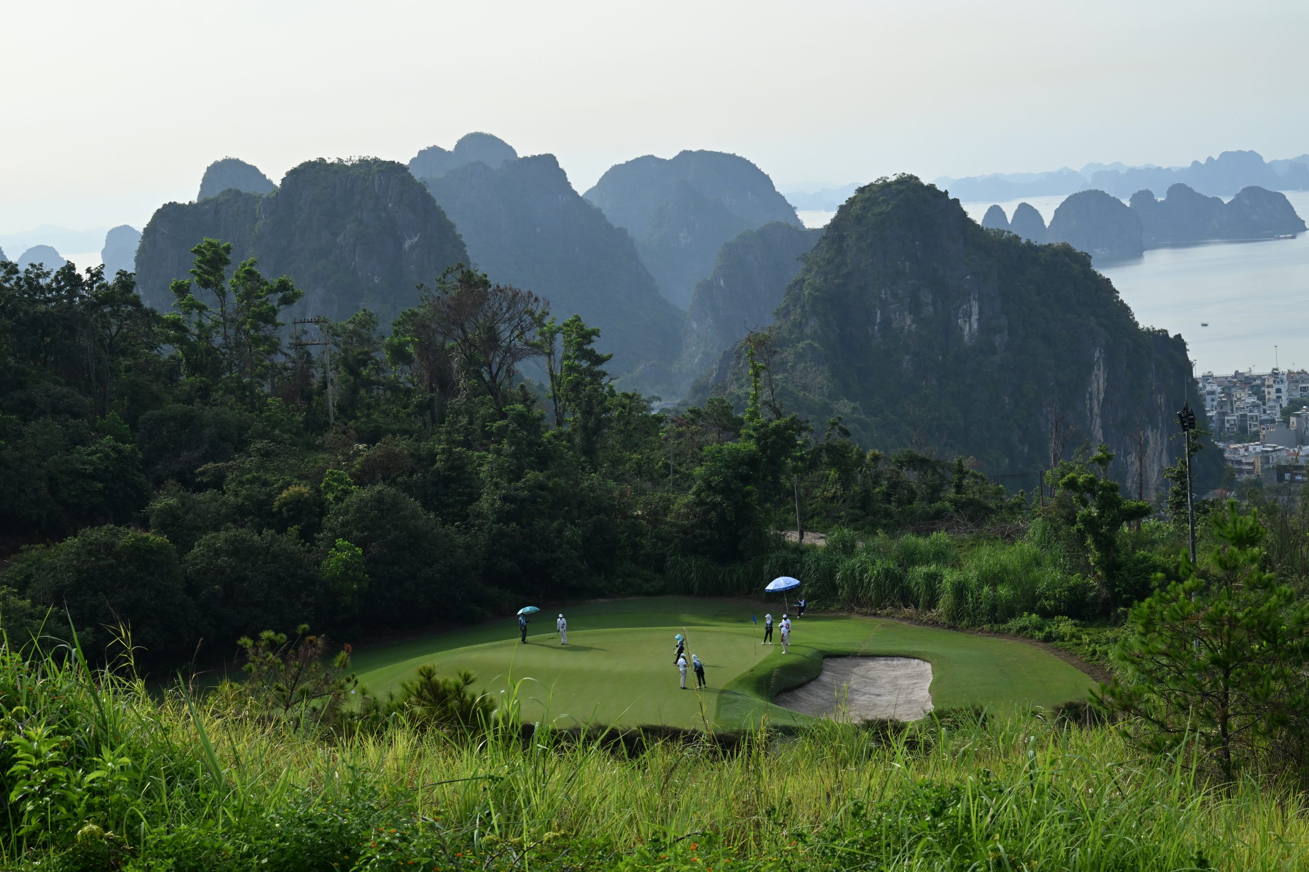 Toàn cảnh sân golf FLC Hạ Long nhìn từ trên cao với khung cảnh núi đá vịnh Hạ Long trong giải golf FLC WAGC Vietnam 2025.